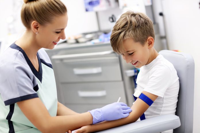 Brave little boy having blood collection for tests