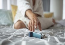 Asmathic girl catching inhaler having an asthma attack