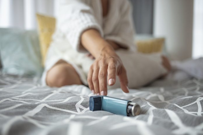 Asmathic girl catching inhaler having an asthma attack