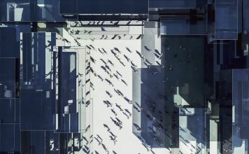 Modern glass office building with business people from above. 3D generated image.
