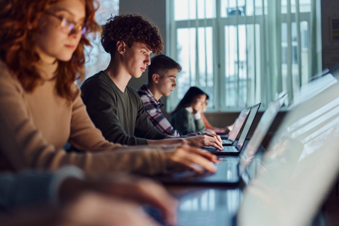 High school students e-learning over computers in the classroom.