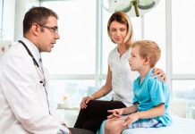 Mother and child in doctor's office stock photo