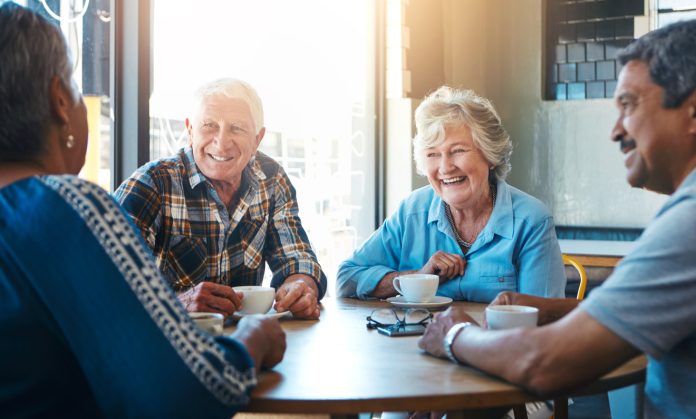 enior, people and group relax on holiday at cafe on vacation in retirement. Elderly, friends and talk at coffee shop with latte, espresso and drink cappuccino and chat in city morning with tea