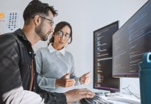 Hispanic Latin American couple, software engineer developer use computer, work on program coding together at home office. Programming language development technology, freelance job concept