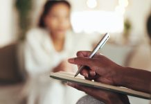 Hands, therapist and writing for counseling patient with depression, psychology assessment and medical report. Woman, psychologist and document for compliance questions, progress information and help