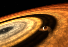 This artistic impression depicts the stage at which WASP-121b accumulated most of its gas, as inferred from the latest results. The illustration suggests that the forming planet had cleared its distant orbit of solid pebbles, which stored water as ice. As a result, the gap prevented additional pebbles from reaching the planet. WASP-121b must have subsequently migrated from the cold, outer regions towards the inner disc, where it now orbits near its star. Credit: T. Müller (MPIA/HdA)