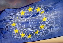 European flag with board in front of dramatic sky