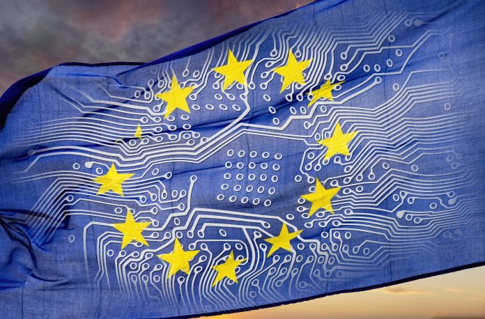 European flag with board in front of dramatic sky