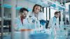 Modern Medical Research Laboratory: Portrait of Latin and Black Young Scientists Using Microscope, Digital Tablet, Doing Sample Analysis, Talking. Diverse Team of Specialists work in Advanced Lab