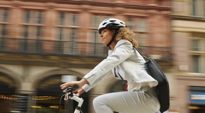 woman cycling through the city centre