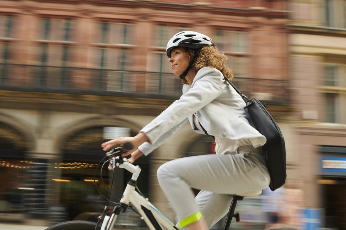 woman cycling through the city centre