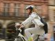 woman cycling through the city centre