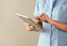 UK nurse using computer tablet browsing the internet