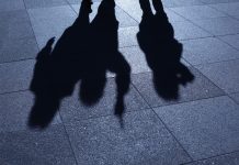 People threatening in blue night shadows