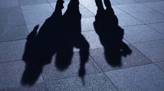 People threatening in blue night shadows