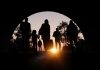 Refugees and immigrants looking for a new hope in life. Silhouette. Column of migrants passing through a tunnel. Abandon your lands for a better future. 3d rendering