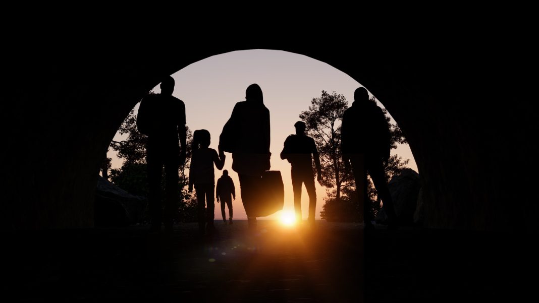 Refugees and immigrants looking for a new hope in life. Silhouette. Column of migrants passing through a tunnel. Abandon your lands for a better future. 3d rendering