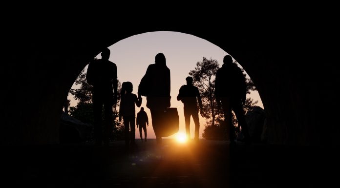 Refugees and immigrants looking for a new hope in life. Silhouette. Column of migrants passing through a tunnel. Abandon your lands for a better future. 3d rendering