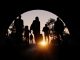 Refugees and immigrants looking for a new hope in life. Silhouette. Column of migrants passing through a tunnel. Abandon your lands for a better future. 3d rendering