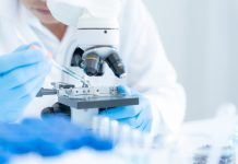 Scientist analyze biochemical samples in advanced scientific laboratory. Medical professional use microscope look microbiological developmental of viral. Biotechnology research in science lab.