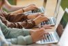 Teenage girls using typing on laptops