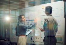 Window, teamwork and whiteboard for brainstorming in meeting, business people with tablet and digital notes with agenda storyboard. Information, ideas with research and calendar for project schedule