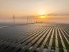 Solar power station and wind power station at sunrise