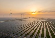 Solar power station and wind power station at sunrise