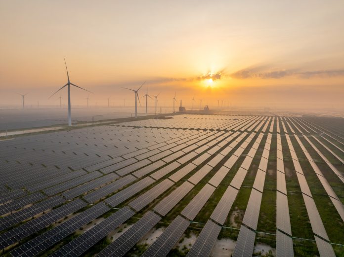 Solar power station and wind power station at sunrise