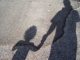 Shadow Of Mother With Son Standing On Road