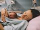Mother and newborn. Child birth in maternity hospital. Young mom hugging her newborn baby after delivery. Woman giving birth. First moments of baby life after labor.