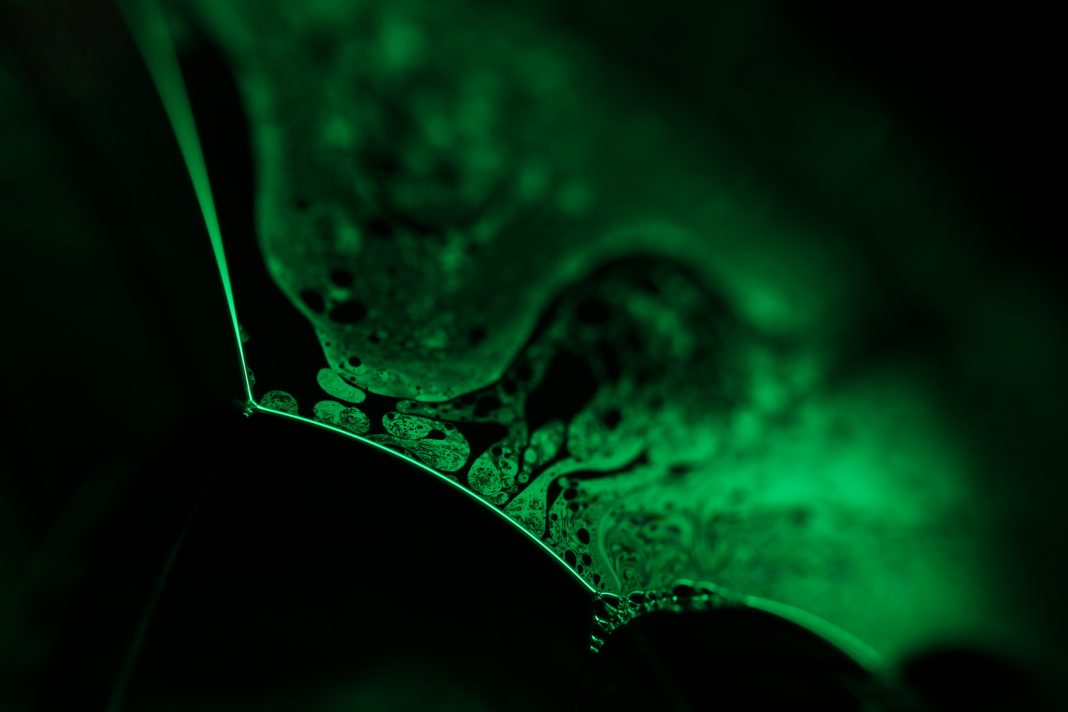 surrealistic art, line of light, chaos of reflection, liquid forms on black. rock weathering research