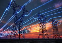 High-Voltage Power Lines at Sunset with Digital Energy Flow