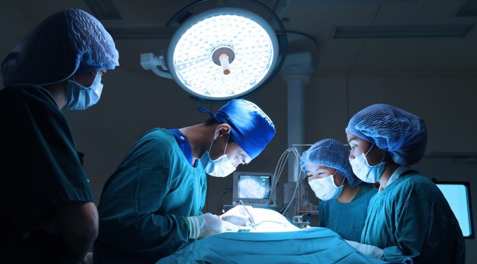 group of veterinarian surgery in operation room take with art lighting and blue filter