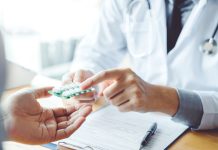 Doctor or physician recommend pills medical prescription to male Patient hospital and medicine concept