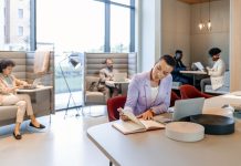 Stylish young short haircut businesswoman working in an open plan office