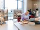 Stylish young short haircut businesswoman working in an open plan office
