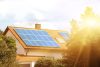 Solar panels on the tiled roof of the building in the sun. Electricity production for own needs and for sale