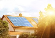 Solar panels on the tiled roof of the building in the sun. Electricity production for own needs and for sale