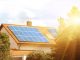 Solar panels on the tiled roof of the building in the sun. Electricity production for own needs and for sale
