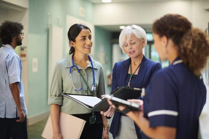 NHS administrator with medical team