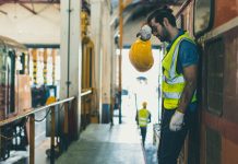 Tired exhausted worker hard work, Locomotive engineer mechanic staff feel fatigue work in train repair shop service station dirty hot workplace machine factory.