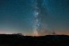 Milky way above the silhouette of mountains