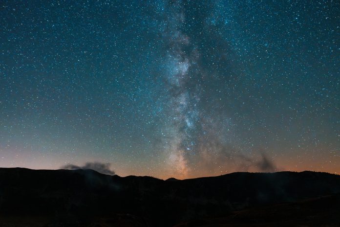 Milky way above the silhouette of mountains