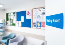 Shallow focus of a typical NHS hospital waiting room sign seen in a British hospital.
