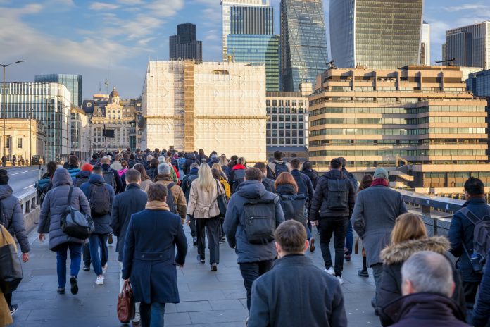 Crowds of commuters on London Bridge rushing into the City