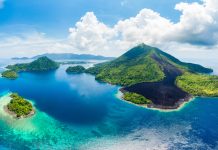 Aerial view Banda Islands Moluccas archipelago Indonesia, Pulau Gunung Api, lava flows, coral reef white sand beach. Top travel tourist destination, best diving snorkeling.