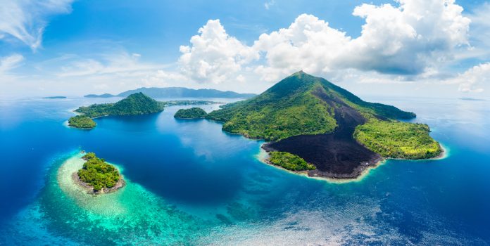 Aerial view Banda Islands Moluccas archipelago Indonesia, Pulau Gunung Api, lava flows, coral reef white sand beach. Top travel tourist destination, best diving snorkeling.
