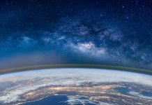 Fish-Eye Lens View Of Earth Against Star Field