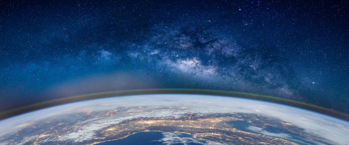 Fish-Eye Lens View Of Earth Against Star Field